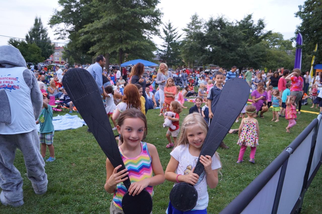Two little girls hold the Share the Fun exclamation points.